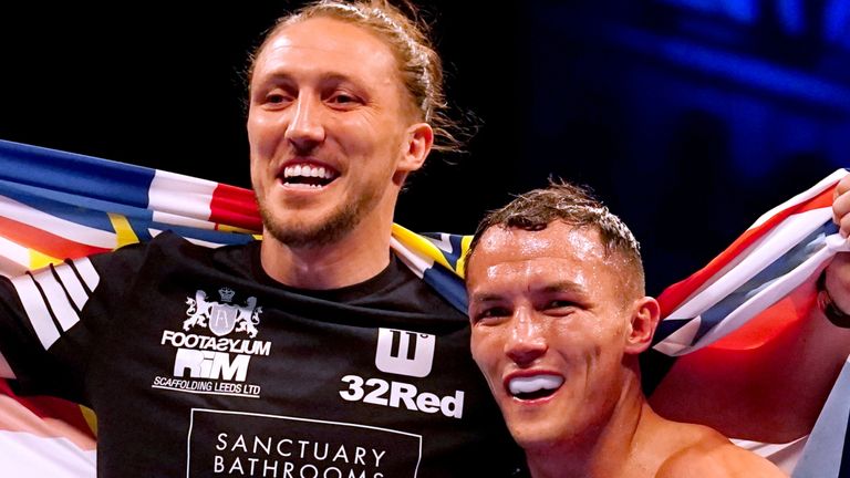 Josh Warrington celebrated in the ring with Leeds defender Luke Ayling