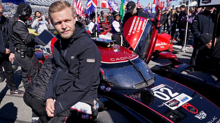 Kevin Magnussen, of Denmark, leans against his car on pit road before the start of the Rolex 24 hour auto race at Daytona International Speedway, Saturday, Jan. 29, 2022, in Daytona Beach, Fla. (AP Photo/John Raoux) 