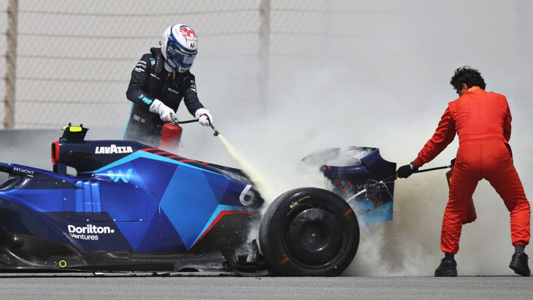 BAHRAIN, BAHRAIN - MARCH 11: Nicholas Latifi of Canada and Williams uses a fire extinguisher on his car after stopping on track during Day Two of F1 Testing at Bahrain International Circuit on March 11, 2022 in Bahrain, Bahrain. (Photo by Mark Thompson/Getty Images)