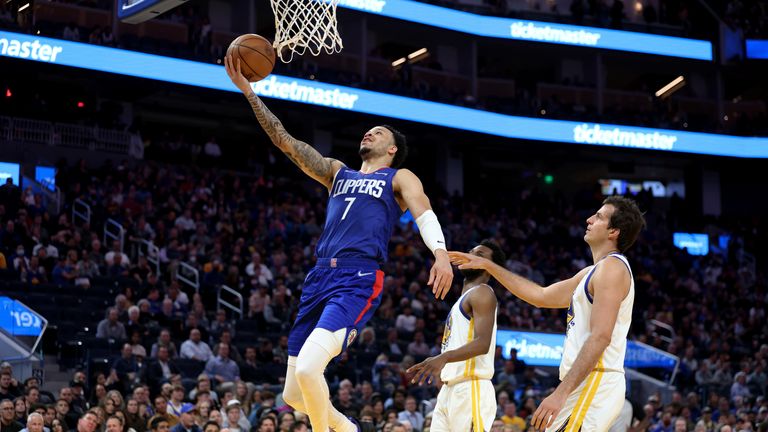 Los Angeles Clippers guard Amir Coffey shoots against Golden State Warriors forward Nemanja Bjelica
