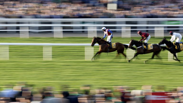 Jonathan Burke stands up in the saddle after crossing the line in front in the Mares' Novices' Hurdle at Cheltenham