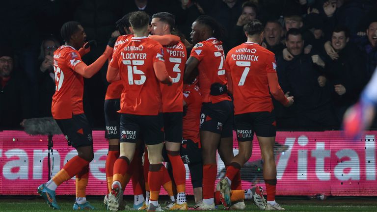 Reece Burke celebrates with his team-mates after giving Luton an early lead against Chelsea