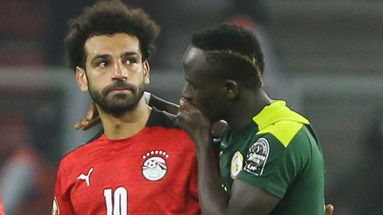 Sadio Mane comforts his Liverpool teammate Mo Salah after Senegal beat Egypt on penalties in the AFCON 2022 final.