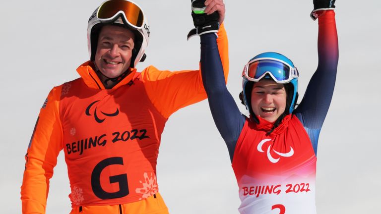 Great Britain's FITZPATRICK Menna and her guide SMITH Gary celebrate after the Women's Super-G Vision Impaired - Para Alpine Skiing at Yanqing National Alpine Skiing Centre in Beijing, China on March 6, 2022. FITZPATRICK placed 2nd in the event to claim the silver medal. ( The Yomiuri Shimbun via AP Images )