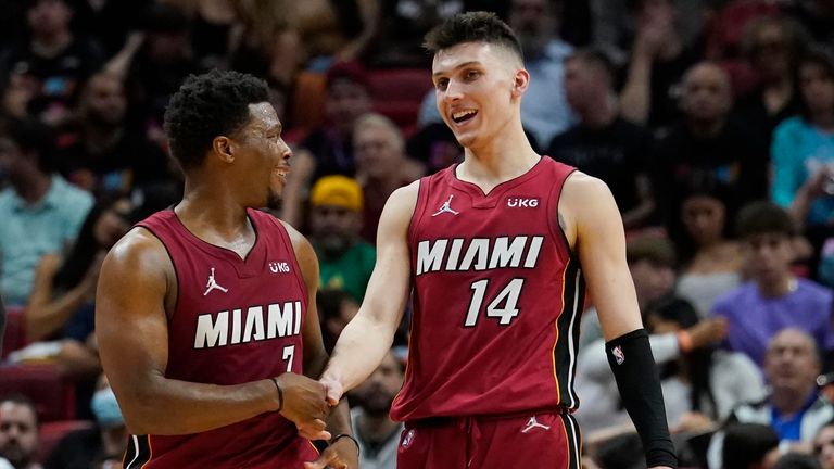 Miami Heat guards Tyler Herro and Kyle Lowry shake hands after Herro made a basket 