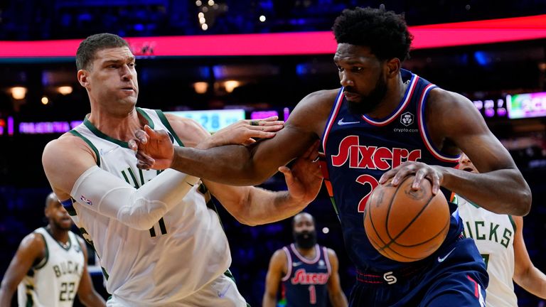 Philadelphia 76ers&#39; Joel Embiid, right, tries to get past Milwaukee Bucks&#39; Brook Lopez during the second half of an NBA basketball game, Tuesday, March 29, 2022, in Philadelphia. 