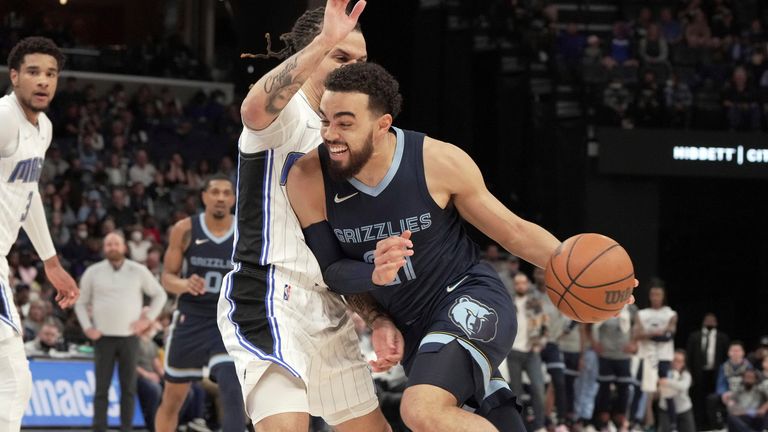Memphis Grizzlies&#39; Tyus Jones, right, gets past Orlando Magic&#39;s Cole Anthony in the first half of an NBA basketball game Saturday, March 5, 2022, in Memphis, Tenn. 