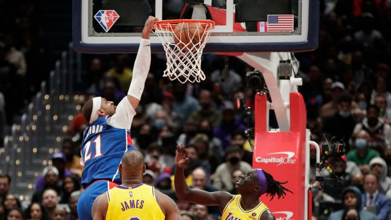Washington Wizards' Daniel Gafford dunks as Los Angeles Lakers' LeBron James and Wenyen Gabriel defend during the second half of an NBA basketball game, Saturday, March 19, 2022, in
