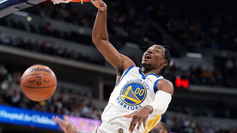 Golden State Warriors forward Jonathan Kuminga dunks against the Denver Nuggets during the first half of an NBA basketball game Thursday, March 10, 2022, in Denver. 