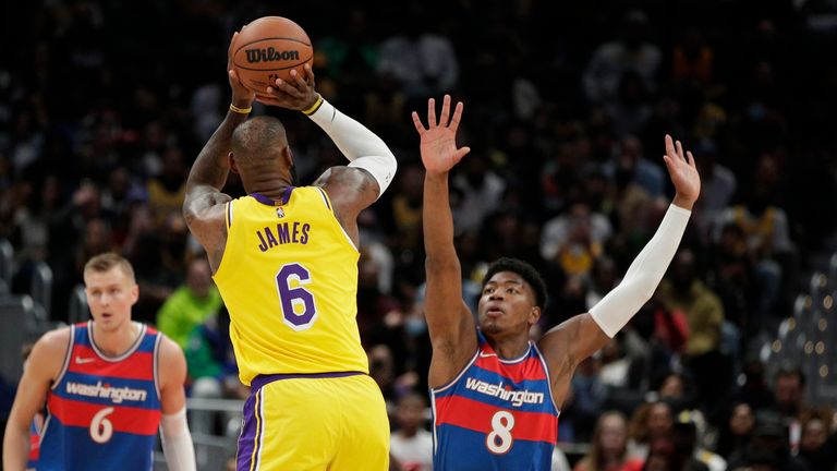 Los Angeles Lakers&#39; LeBron James shoots as Washington Wizards&#39; Rui Hachimura defends during the first half of an NBA basketball game, Saturday, March 19, 2022, in Washington.