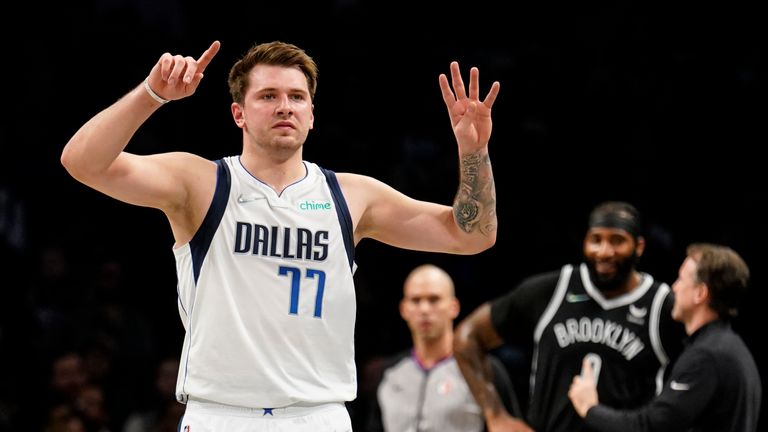 Dallas Mavericks guard Luka Doncic (77) signals to his bench in the first half of an NBA basketball game against the Brooklyn Nets, Wednesday, March 16, 2022, in New York. (AP Photo/John Minchillo)