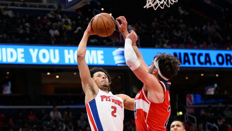 Detroit Pistons guard Cade Cunningham (2) goes to the basket against Washington Wizards forward Corey Kispert, right, during the second half of an NBA basketball game