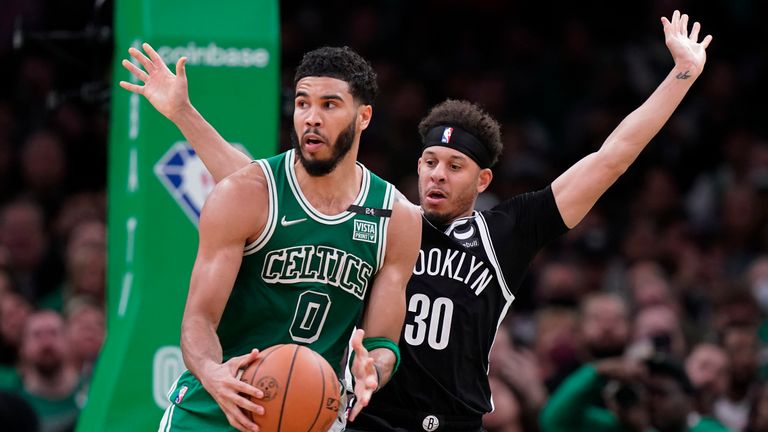 Boston Celtics forward Jayson Tatum (0) looks for an opening as Brooklyn Nets guard Seth Curry (30) tries to defend in the second half of an NBA basketball game, Sunday, March 6, 2022, in Boston. The Celtics won 126-120 over the Nets. (AP Photo/Steven Senne)


