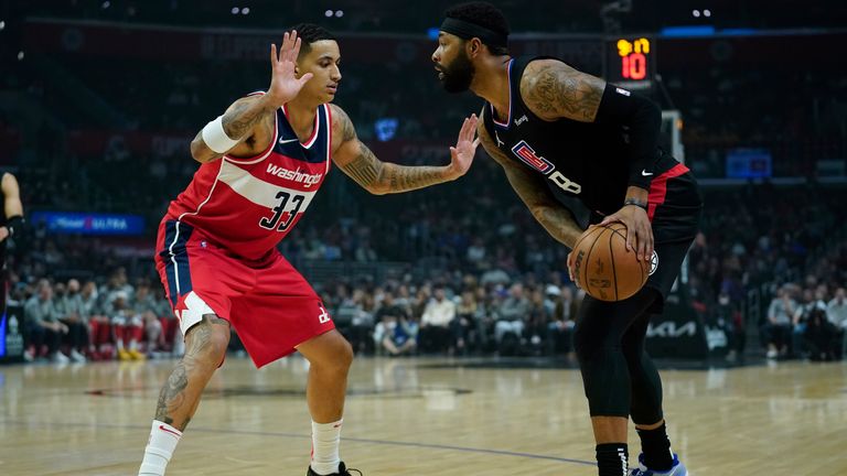 Washington Wizards forward Kyle Kuzma (33) defends against LA Clippers forward Marcus Morris Sr. (8) during the first half of an NBA basketball game in Los Angeles, Wednesday, March 9, 2022. 