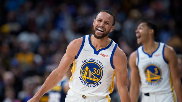 Golden State Warriors guard Stephen Curry celebrates after guard Jordan Poole, back, hit a 3-point basket late in the second half of the team&#39;s NBA basketball game against the Denver Nuggets on Thursday, March 10, 2022, in Denver. 