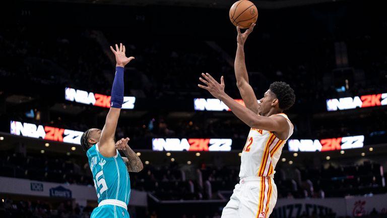 Charlotte Hornets forward P.J. Washington (25) defends against Atlanta Hawks forward De'Andre Hunter (12) during the second half of an NBA basketball game Wednesday, March 16, 2022, in Charlotte, N.C. (AP Photo/Matt Kelley)