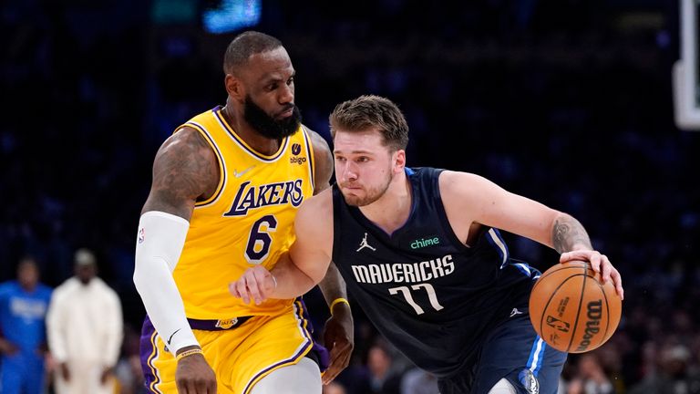 Dallas Mavericks guard Luka Doncic, right, drives past Los Angeles Lakers forward LeBron James during the second half of an NBA basketball