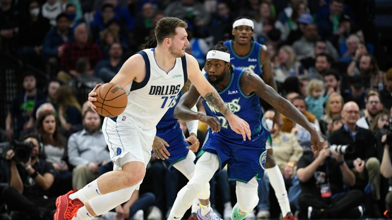 Dallas Mavericks guard Luka Doncic, left, drives past Minnesota Timberwolves guard Patrick Beverley during the first half of an NBA basketball game Friday, March 25, 2022, in Minneapolis. (AP Photo/Craig Lassig)



