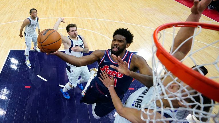 Philadelphia 76ers&#39; Joel Embiid, center, goes up for a shot against Dallas Mavericks&#39; Dwight Powell during the first half of an NBA basketball game, Friday, March 18, 2022, in Philadelphia. (AP Photo/Matt Slocum)


