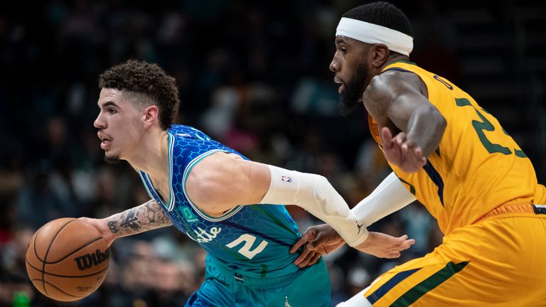 Charlotte Hornets guard LaMelo Ball (2) drives past Utah Jazz forward Royce O&#39;Neale (23) during the second half of an NBA basketball game, Friday, March 25, 2022, in Charlotte, N.C. (AP Photo/Matt Kelley)


