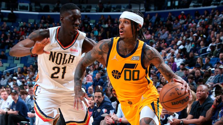 In a photo provided by the New Orleans Pelicans, Utah Jazz guard Jordan Clarkson (00) drives to the basket against New Orleans Pelicans forward Tony Snell (21) during an NBA basketball game Friday, March 4, 2022, in New Orleans.