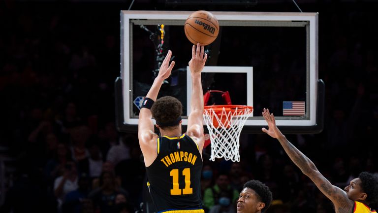 Golden State Warriors guard Klay Thompson (11) shoots a 3-point basket during the first half of an NBA basketball game against the Atlanta Hawks, Friday, March 25, 2022, in Atlanta. (AP Photo/Hakim Wright Sr.)


