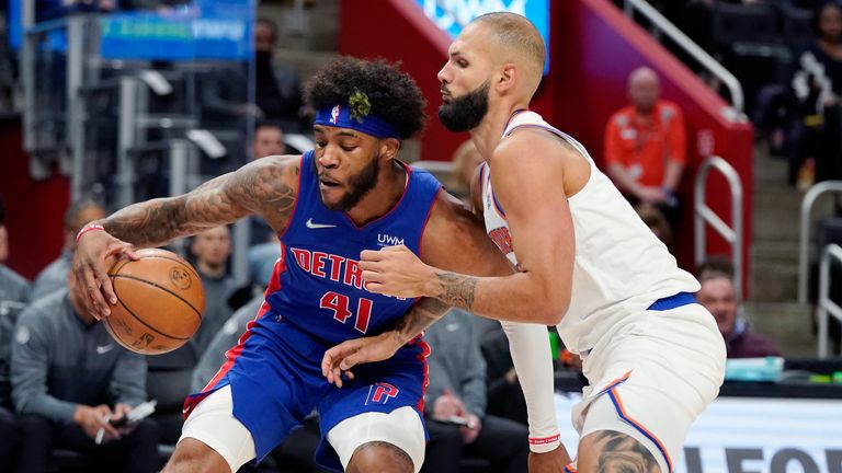 Detroit Pistons forward Saddiq Bey (41) is defended by New York Knicks guard Evan Fournier during the first half of an NBA basketball game, Sunday, March 27, 2022, in Detroit.