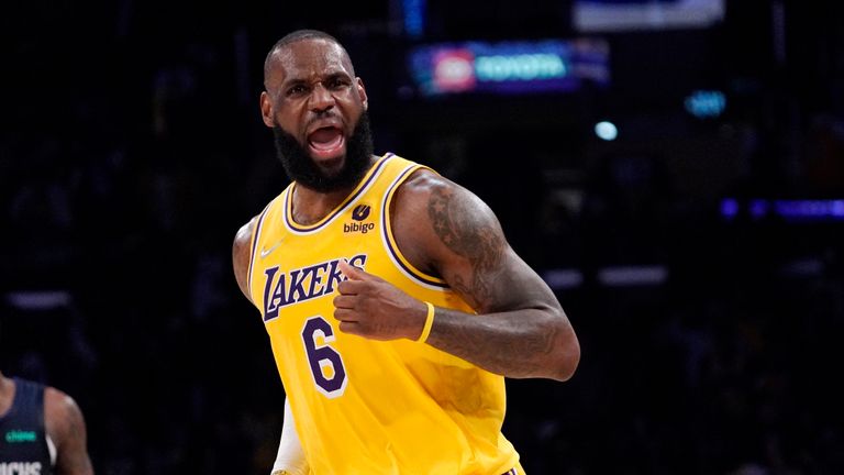 Los Angeles Lakers forward LeBron James celebrates after scoring during the second half of an NBA basketball game against the Dallas Mavericks
