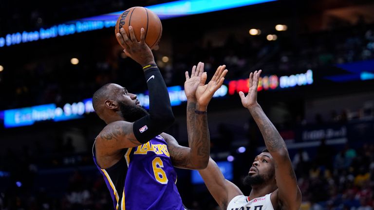 Los Angeles Lakers forward LeBron James (6) shoots against New Orleans Pelicans forward Naji Marshall in the first half of an NBA basketball game in New Orleans, Sunday, March 27, 2022.