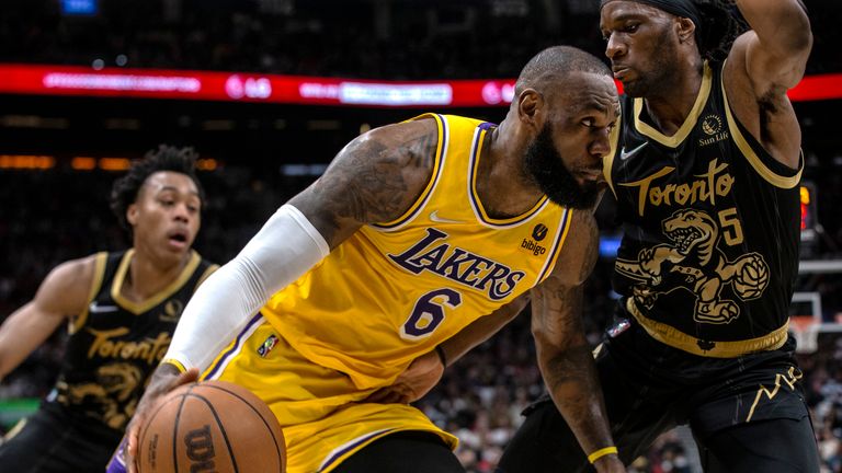 Los Angeles Lakers LeBron James (6) drives at Toronto Raptors Precious Achiuwa during the second half of an NBA basketball game in Toronto on Friday, March 18, 2022. (Chris Young/The Canadian Press via AP)


