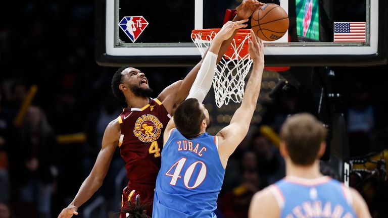 Cleveland Cavaliers' Evan Mobley (4) blocks a shot by Los Angeles Clippers' Ivica Zubac (40) during overtime of an NBA basketball game, Monday, March 14, 2022, in Cleveland.