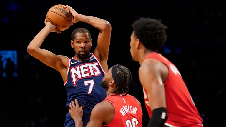 Brooklyn Nets forward Kevin Durant (7) looks to pass against Portland Trail Blazers forward Justise Winslow (26) in the second half of an NBA basketball game, Friday, March 18, 2022, in New York. (AP Photo/John Minchillo)


