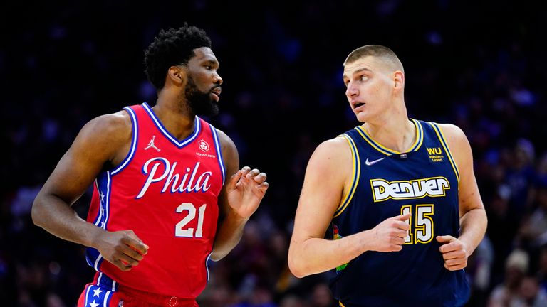 Philadelphia 76ers&#39; Joel Embiid, left, and Denver Nuggets&#39; Nikola Jokic jog down court during the first half of an NBA basketball game, Monday, March 14, 2022, in Philadelphia.