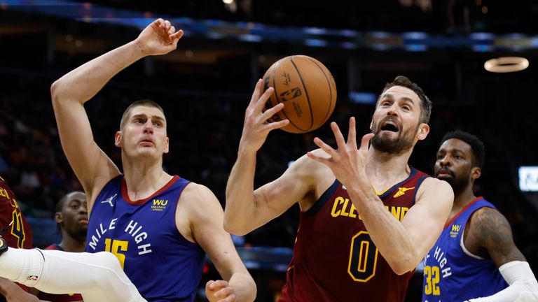 Cleveland Cavaliers&#39; Kevin Love (0) rebounds the ball against Denver Nuggets&#39; Nikola Jokic (15) during the second half of an NBA basketball game, Friday, March 18, 2022, in Cleveland. (AP Photo/Ron Schwane)


