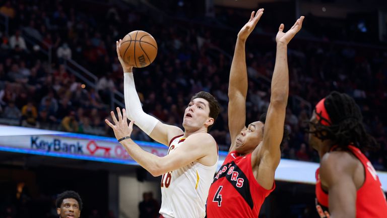 Cleveland Cavaliers&#39; Cedi Osman (16) shoots against Toronto Raptors&#39; Scottie Barnes (4) during the first half of an NBA basketball game, Sunday, March 6, 2022, in Cleveland. (AP Photo/Ron Schwane)


