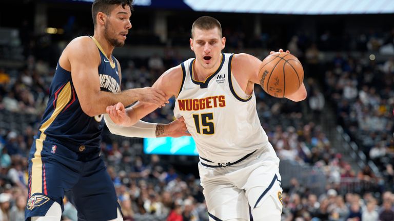 Denver Nuggets center Nikola Jokic, right, drives the lane to the rim as New Orleans Pelicans center Willy Hernangomez defends in the first half of an NBA basketball game Sunday, March 6, 2022, in Denver. (AP Photo/David Zalubowski)


