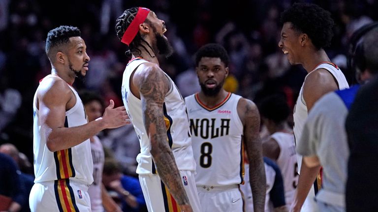 New Orleans Pelicans forward Brandon Ingram, second left, celebrates with guard CJ McCollum, left, guard Trey Murphy III, right, and forward Naji Marshall (8) after defeating the Los Angeles Lakers in an NBA basketball game in New Orleans, Sunday, March 27, 2022. The Pelicans won 116-108.