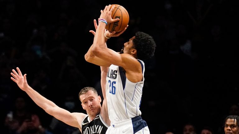 Dallas Mavericks guard Spencer Dinwiddie (26) shoots the game-winning three point shot at the buzzer against Brooklyn Nets guard Goran Dragic (9) in the second half of an NBA basketball game, Wednesday, March 16, 2022, in New York. (AP Photo/John Minchillo)