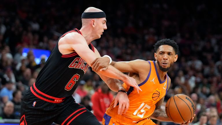 Phoenix Suns guard Cameron Payne (15) shields the ball from Chicago Bulls guard Alex Caruso during the second half of an NBA basketball game Friday, March 18, 2022, in Phoenix. Phoenix won 129-102. (AP Photo/Rick Scuteri)



