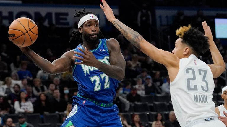 Minnesota Timberwolves guard Patrick Beverley (22) passes around Oklahoma City Thunder guard Tre Mann (23) in the first half of an NBA basketball game Friday, March 4, 2022, in Oklahoma City.