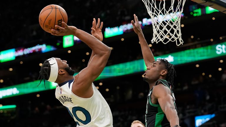 Minnesota Timberwolves forward Josh Okogie (20), left, takes a shot at the basket as Boston Celtics forward Aaron Nesmith (26), right, tries to defend in the second half of an NBA basketball game, Sunday, March 27, 2022, in Boston. The Celtics won 134-112. 