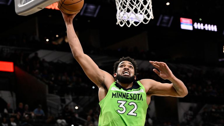 Minnesota Timberwolves' Karl-Anthony Towns dunks during the first half of an NBA basketball game against the San Antonio Spurs on Monday, March 14, 2022, in San Antonio.