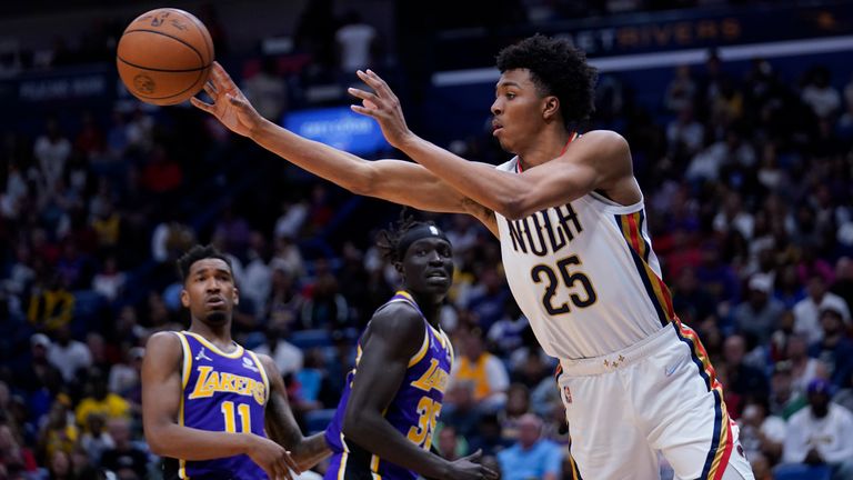 New Orleans Pelicans guard Trey Murphy III (25) passes under the basket in the second half of an NBA basketball game against the Los Angeles Lakers in New Orleans, Sunday, March 27, 2022. The Pelicans won 116-108.