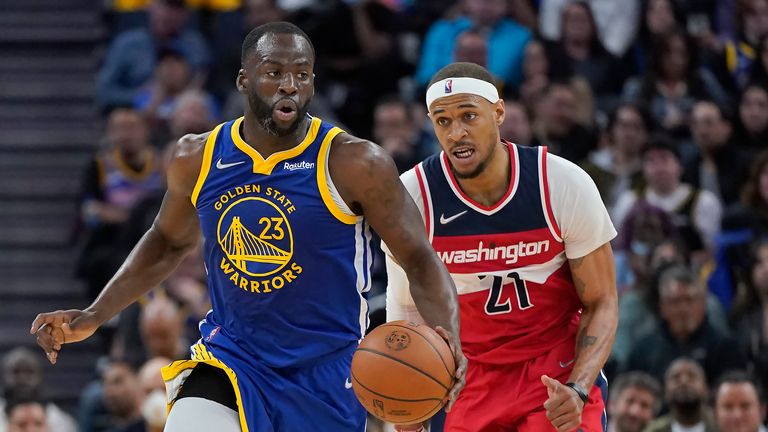 Golden State Warriors forward Draymond Green (23) dribbles upcourt in front of Washington Wizards center Daniel Gafford (21) during the second half of an NBA basketball game in San Francisco, Monday, March 14, 2022.
