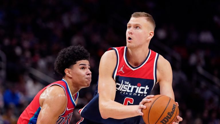 Washington Wizards center Kristaps Porzingis (6) is defended by Detroit Pistons guard Killian Hayes during the second half of an NBA basketball game, Friday, March 25, 2022, in Detroit. (AP Photo/Carlos Osorio)


