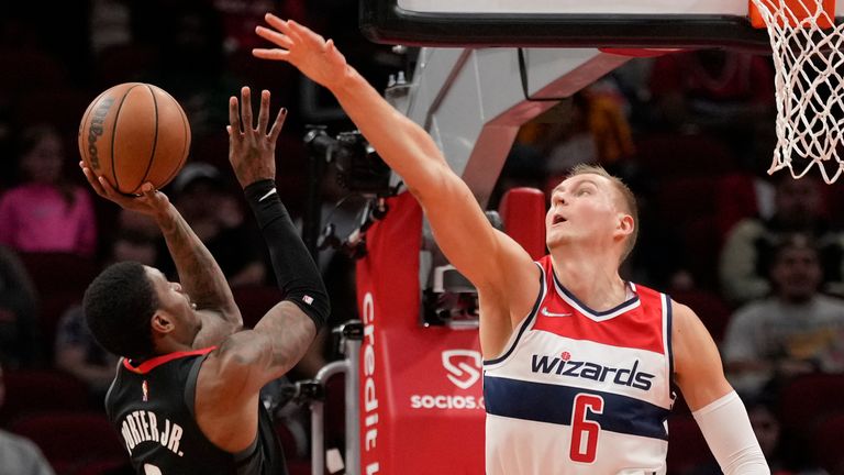 Houston Rockets guard Kevin Porter Jr., left, shoots as Washington Wizards center Kristaps Porzingis (6) defends during the first half of an NBA basketball game, Monday, March 21, 2022, in Houston.