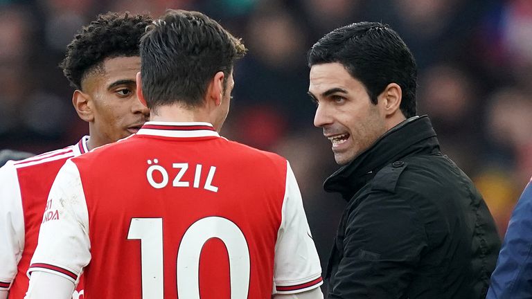 Ozil fell out with Arsenal manager Mikel Arteta (right) in a similar cloud of controversy
