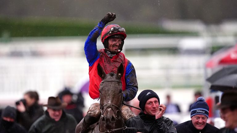 Patrick Mullins celebrates as a muddy Facile Vega returns to the winner's enclosure at Cheltenham