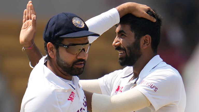 India's captain Rohit Sharma (L) celebrates on field with team-mate Jasprit Bumrah