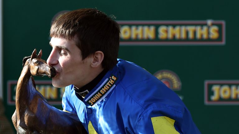Ryan Mania kisses his trophy after winning the 2013 Grand National